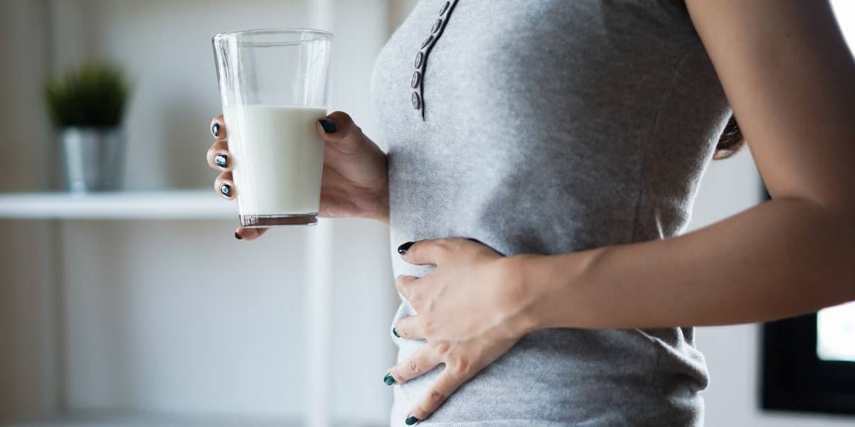 intolerante-a-la-lactosa mujer con intolerancia a la lactosa con dolor después de tomar leche